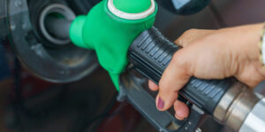 Alt text: Driver pumping gasoline at a fuel station in Connecticut